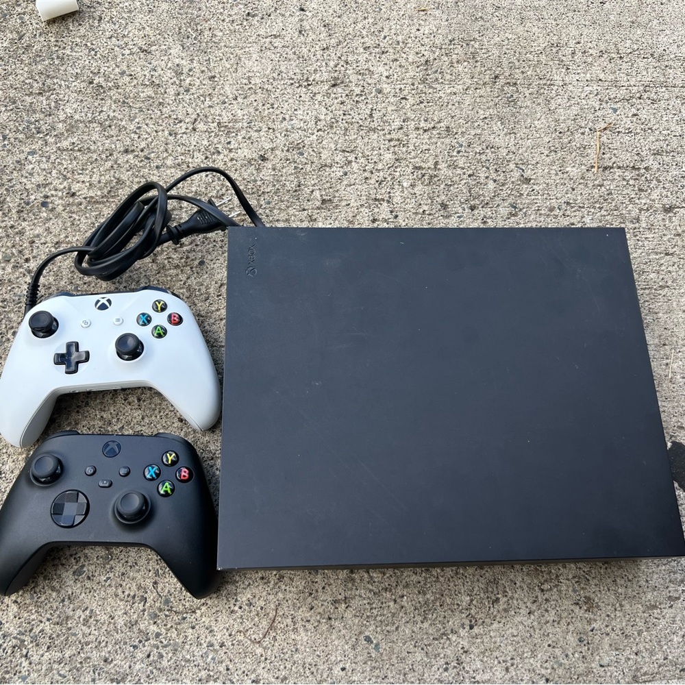 X box one X Console with Black and White Controllers